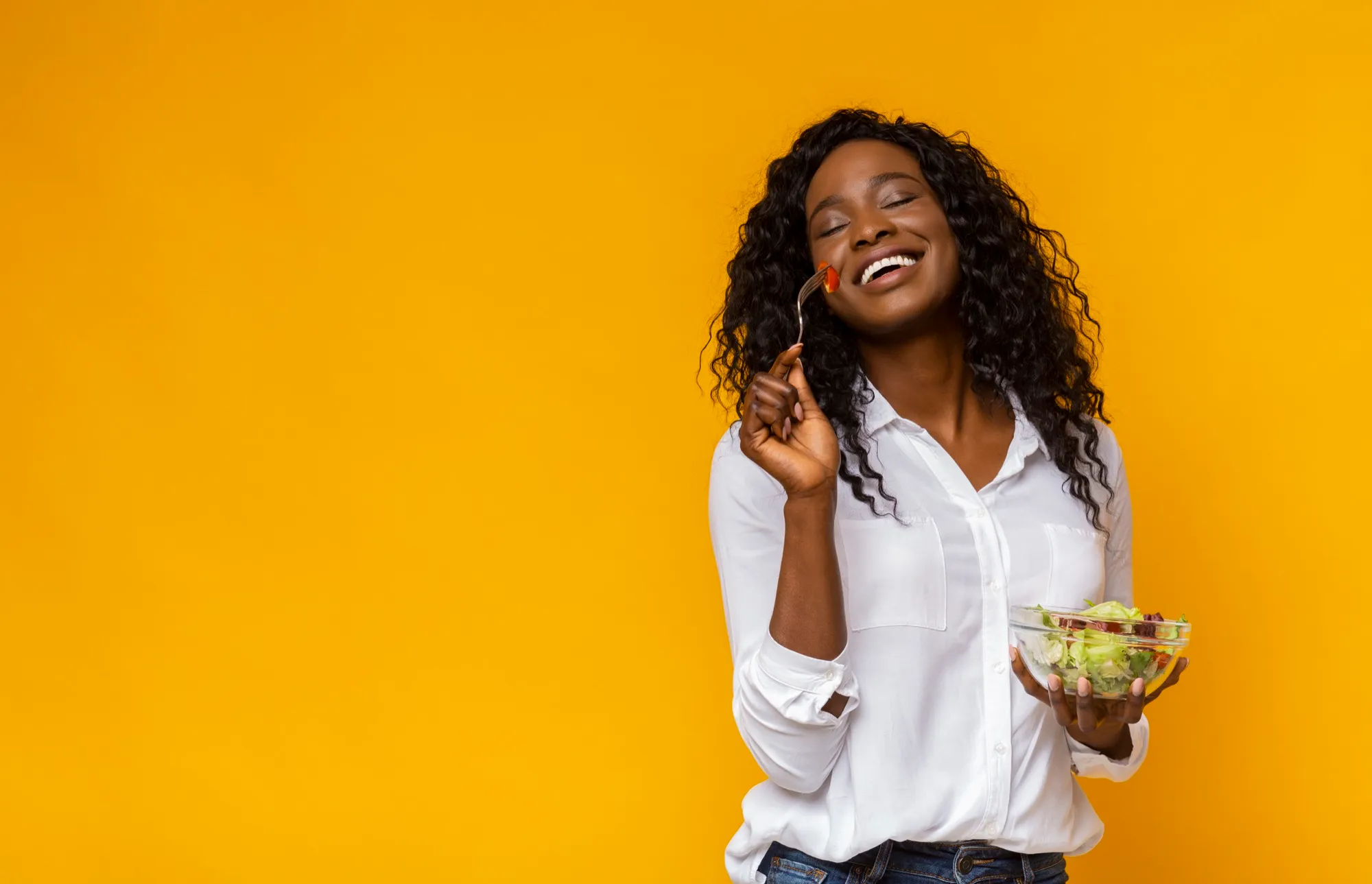 Mulher feliz a comer salada saudável